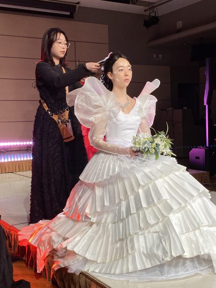 Collectionstageで赤と白のドレスを着たモデル